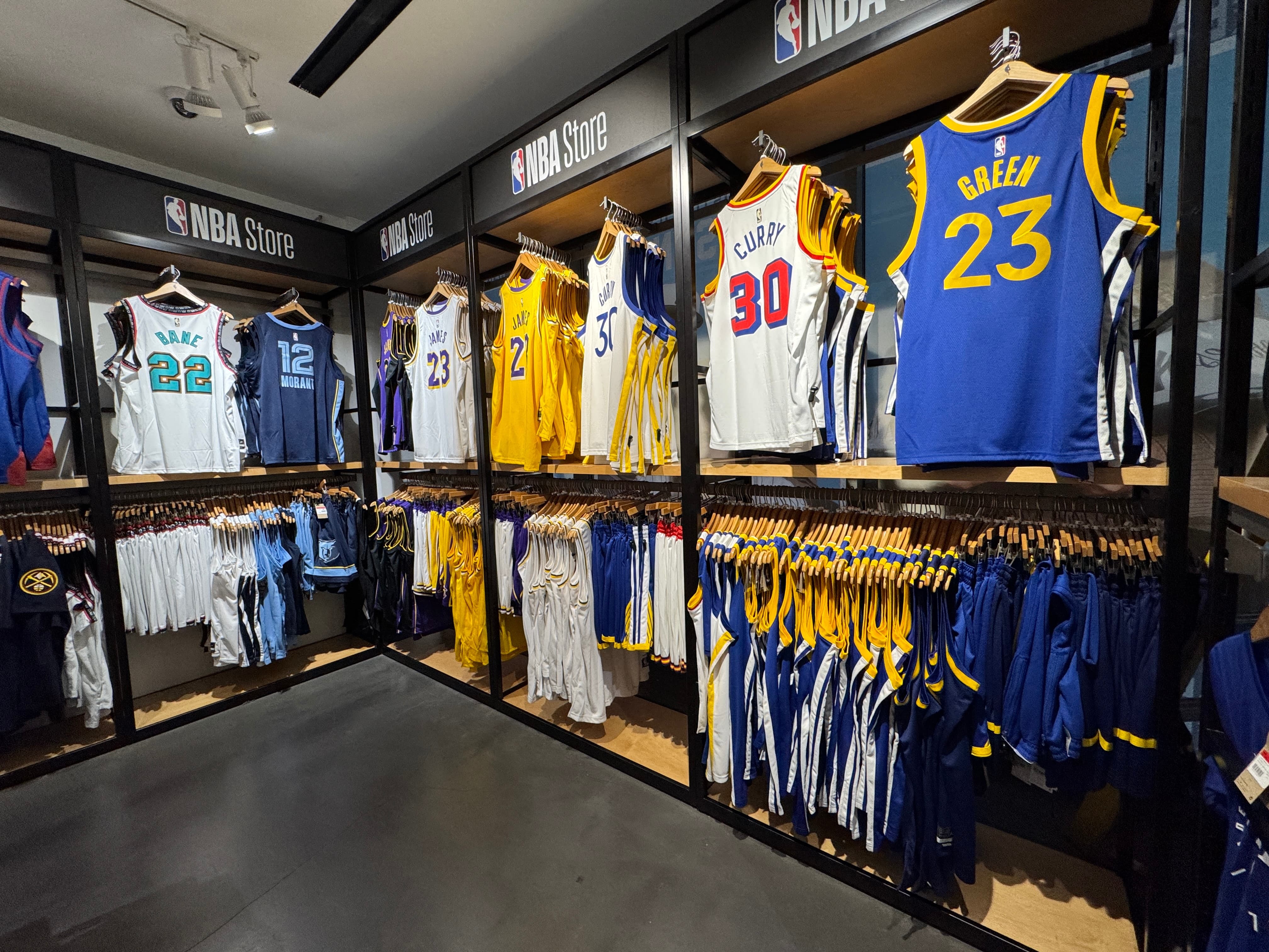 The inside of the NBA store, showing a variety of team kits