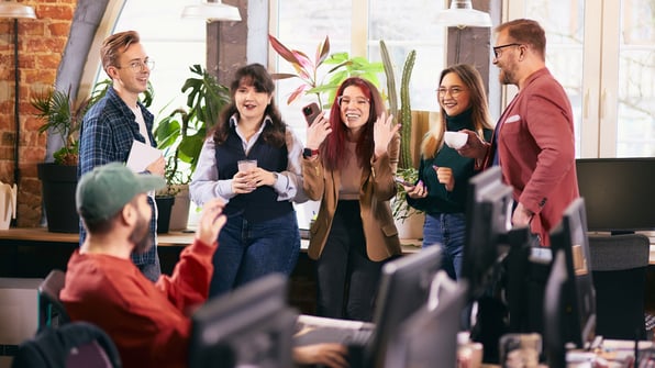 A group of employees standing together and laughing