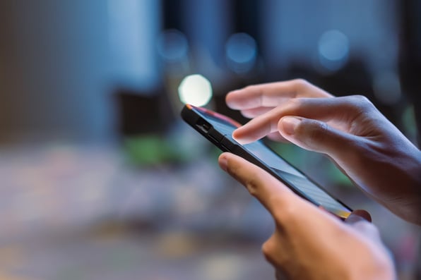 A close up of someone's hands using a smartphone