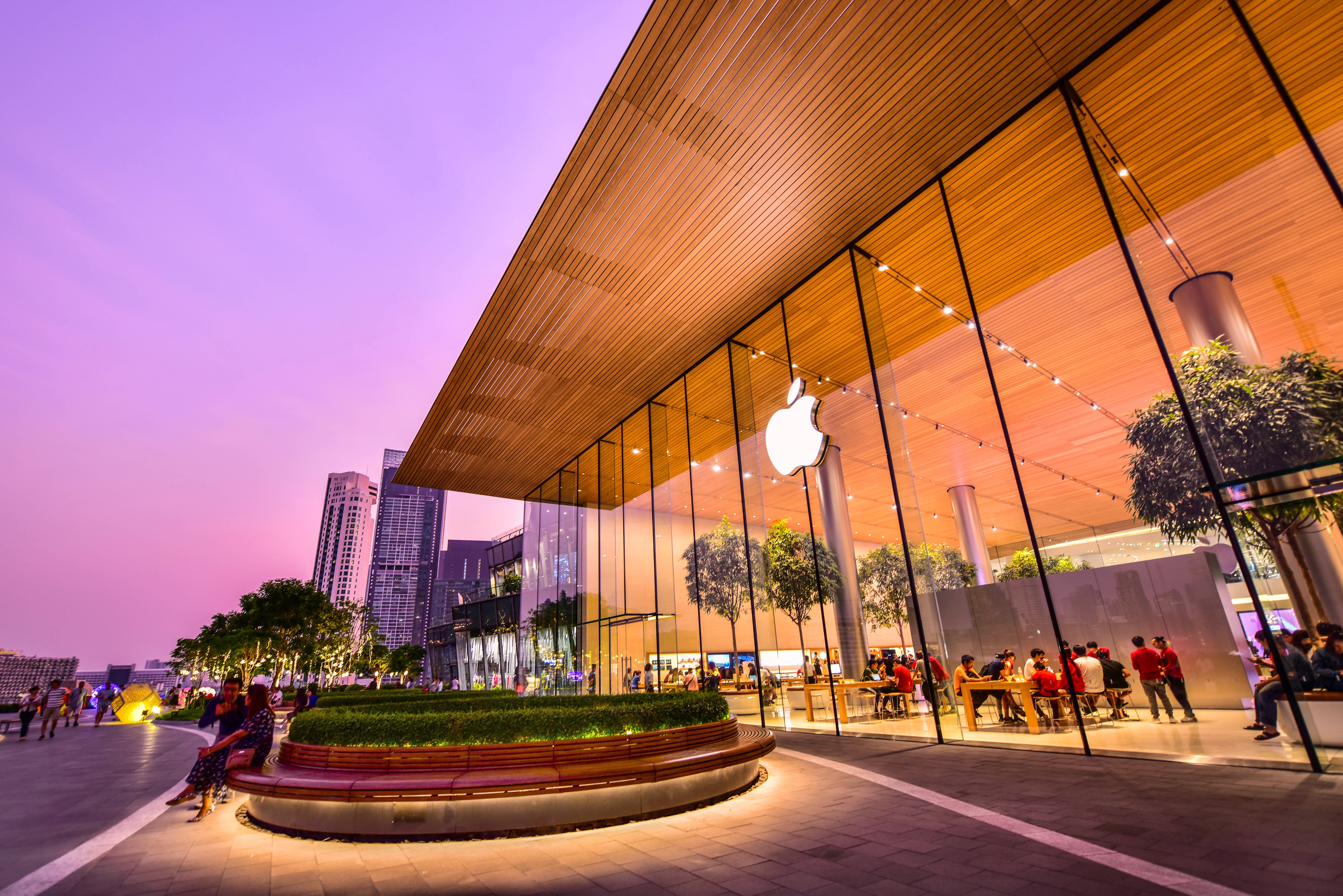 The outside of an Apple store, with lots of people visible inside