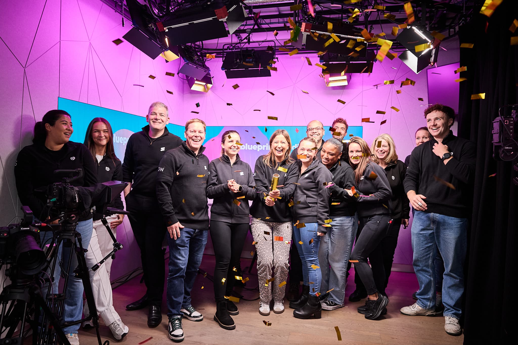 The Blueprint Studios London team in the studio laughing as a confetti cannon goes off